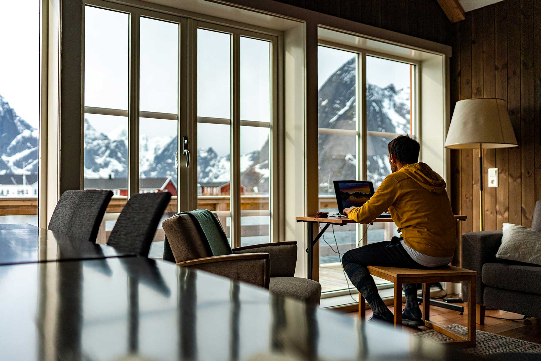 Man working in his home office overlooking Norway landscape