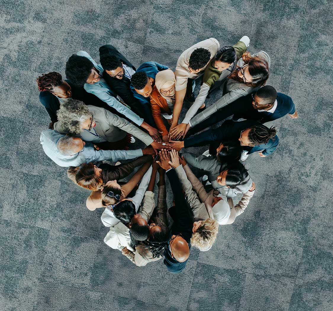 Group of diverse man and woman standing in the circle reaching their hands in the middle