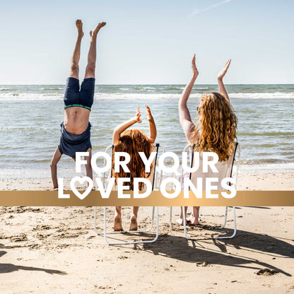 A family enjoys time on the beach, with the dad doing a handstand while the mom and daughter clap and cheer, promoting an active and joyful lifestyle. Text overlay reads "For your loved ones."