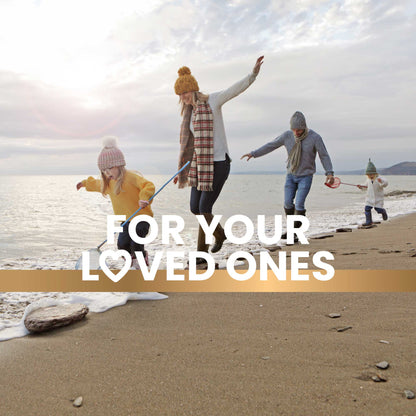 A family spends time on the beach in winter clothing, with kids holding nets for catching fish, showcasing an outdoor adventure and promoting a healthy, active lifestyle. Text overlay reads "For your loved ones."